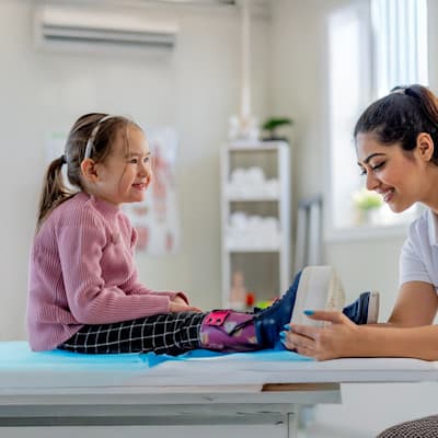 Children's Nebraska provider fitting patient for leg braces.