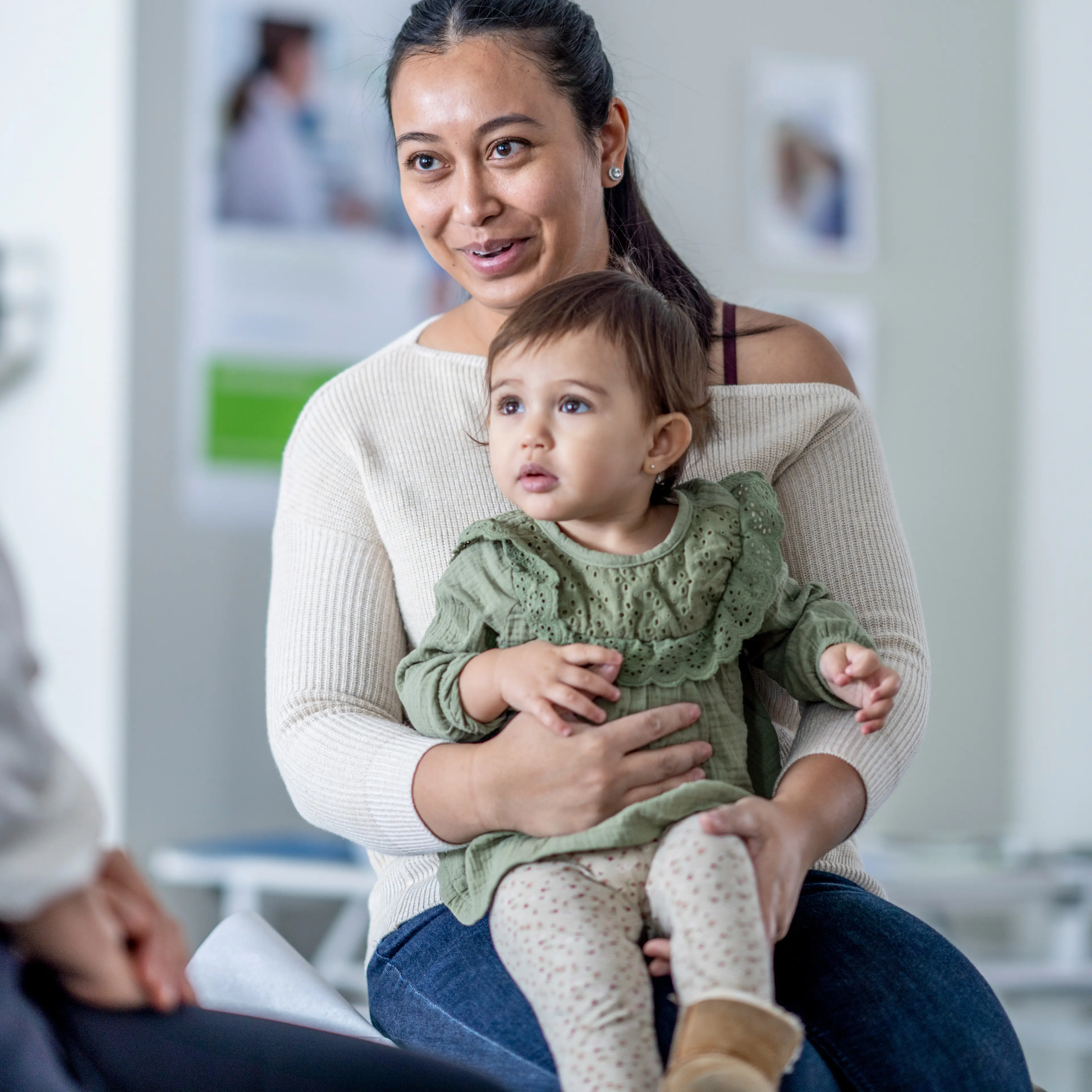 Provider speaking with mother and young patient.