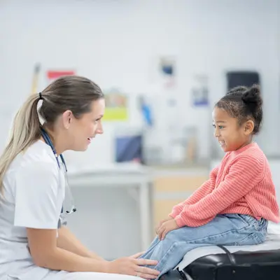 Provider talking to young patient.