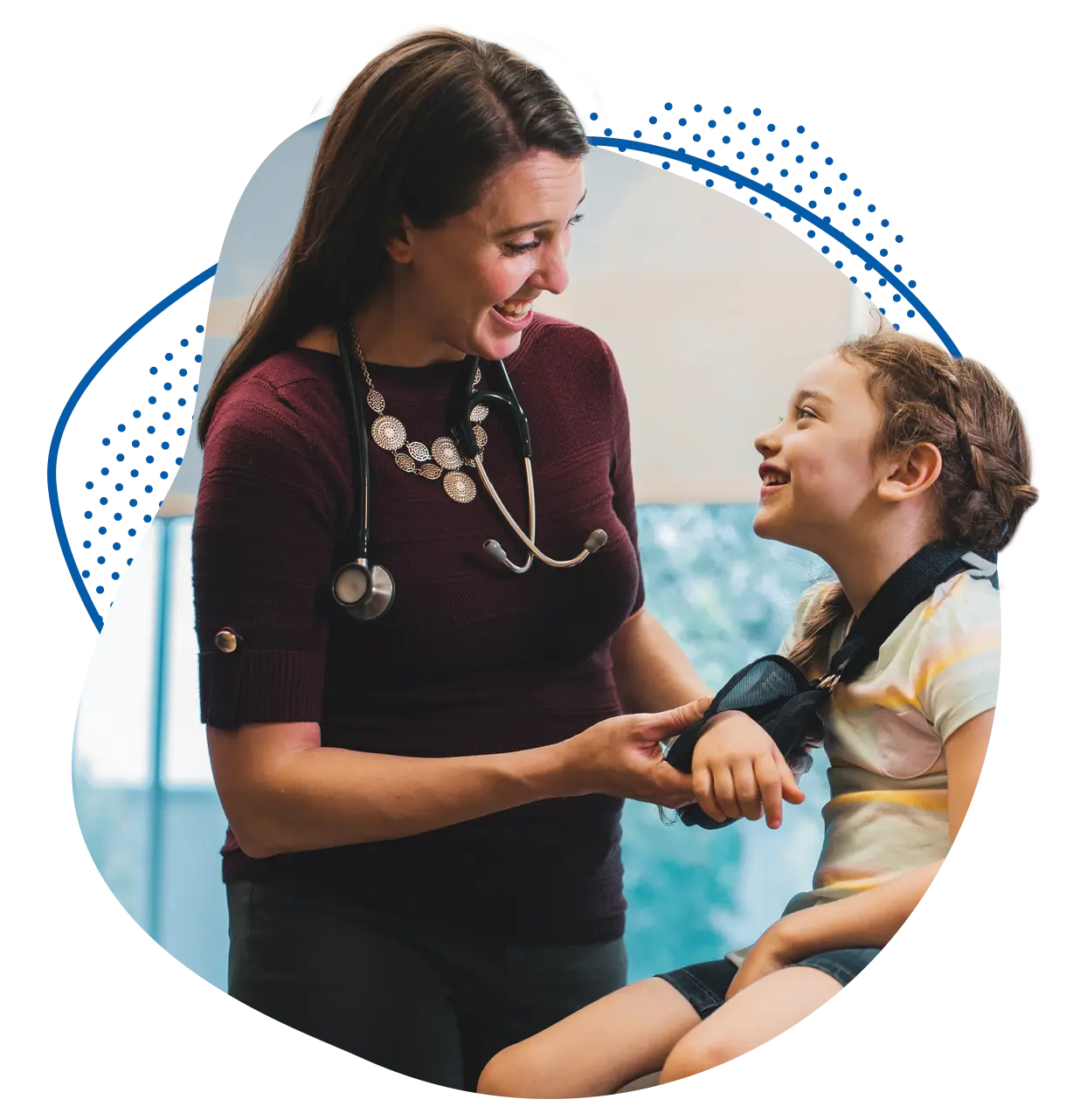 Children's provider fitting young patient with an arm sling.