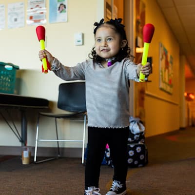 Young girl completing therapy exercise.