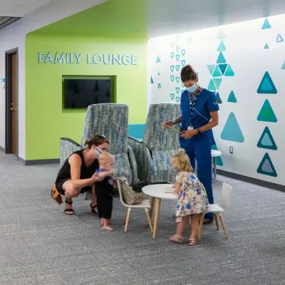 Children's Nebraska provider talking with family in the family lounge.