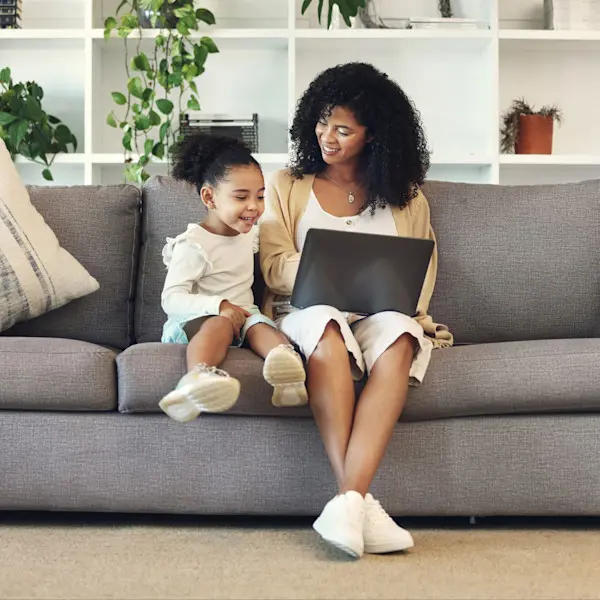 Family, mother and child with laptop in home living room.
