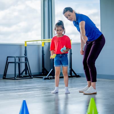 Therapist helping child with exercises.