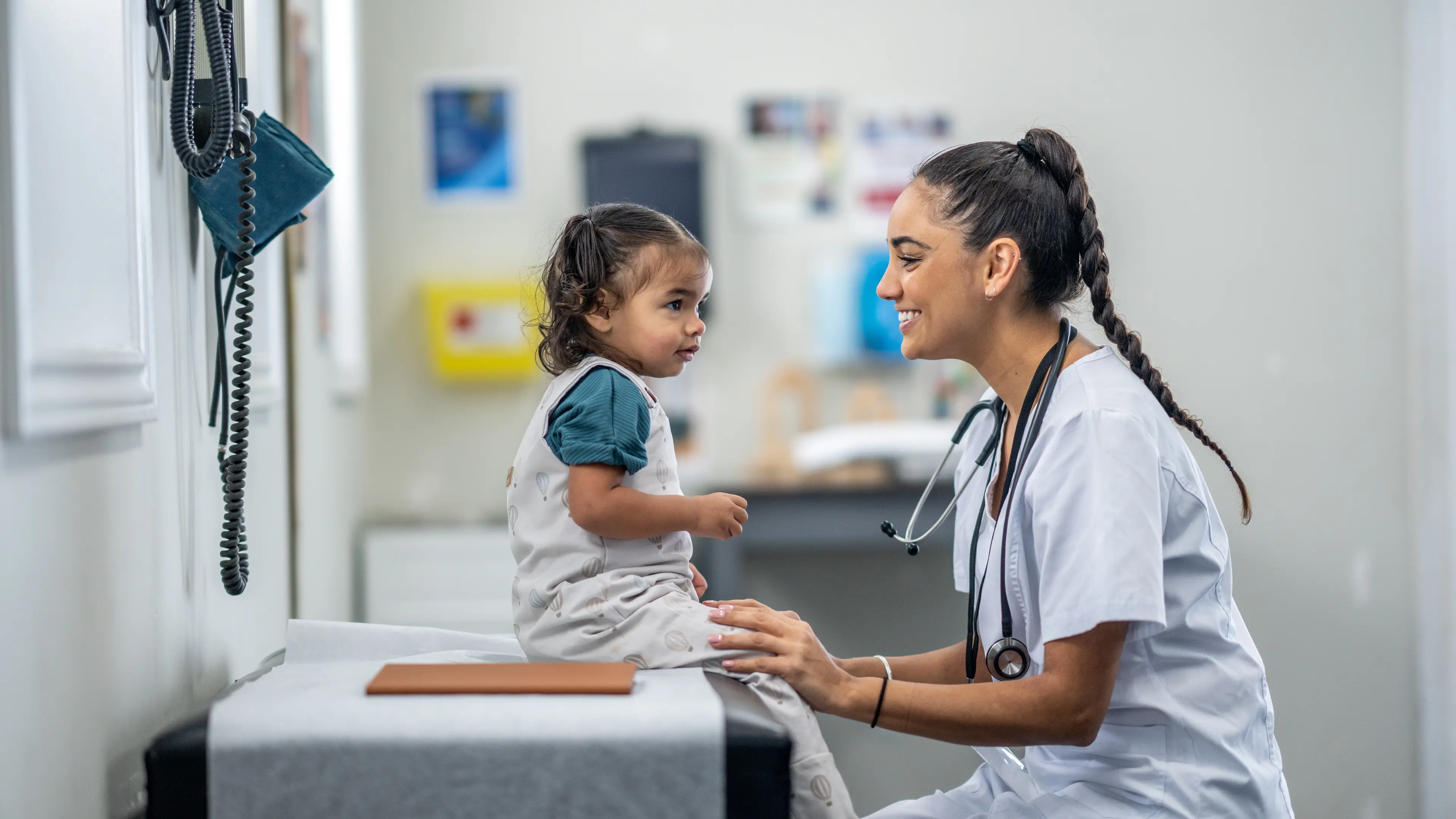 Nurse smiling with young patient.