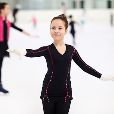 Young girl practicing figure skating.
