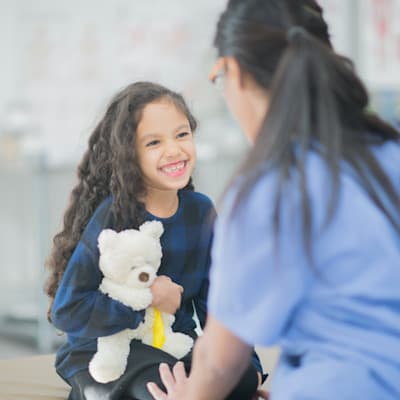 Provider smiling with young patient.