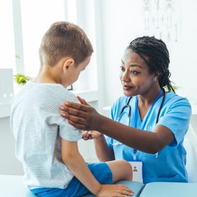 Provider examining young patient.