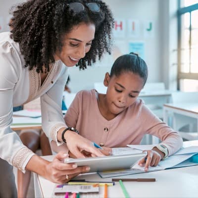 Teaching working with young girl in class.