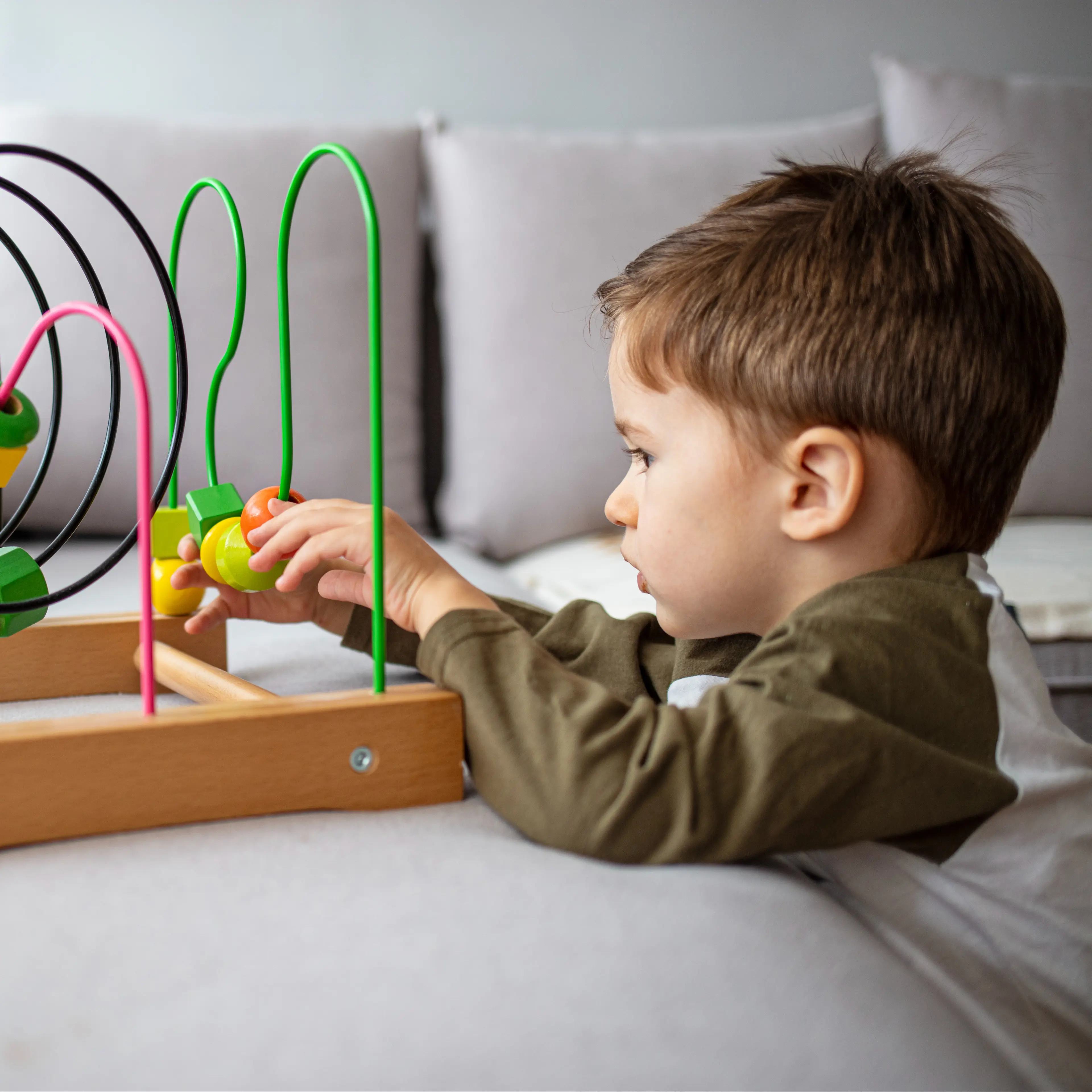 Young autistic child playing with toy.