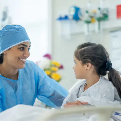 Nurse comforting patient in hospital.