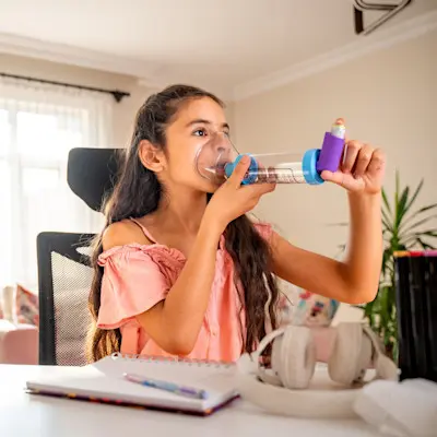Young girl using an inhaler.