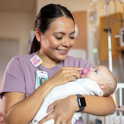 Provider smiling at infant patient.