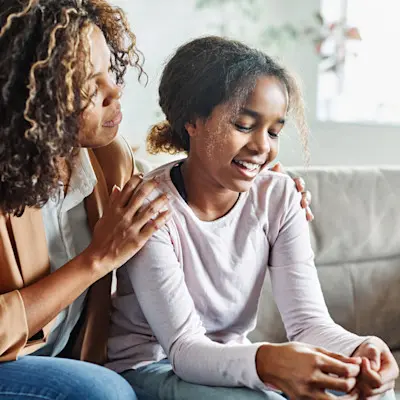 Mother comforting teenage daughter.