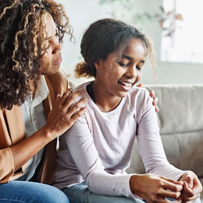 Mother comforting teenage daughter.