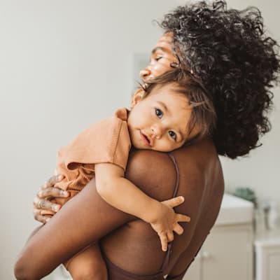 Mother holding child.