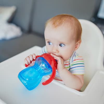 Toddler drinking out of sippy cup.