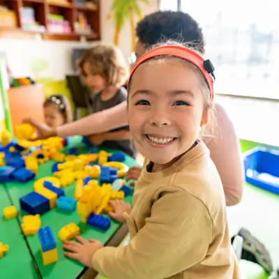 Young girl with cochlear implant playing with other children.
