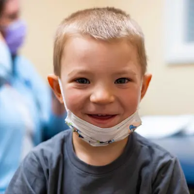 Karter, a children's patient, smiling at the camera.