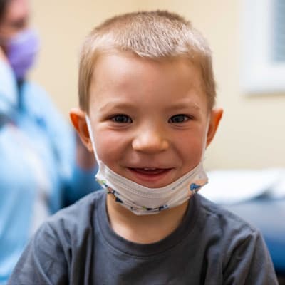 Karter, a children's patient, smiling at the camera.