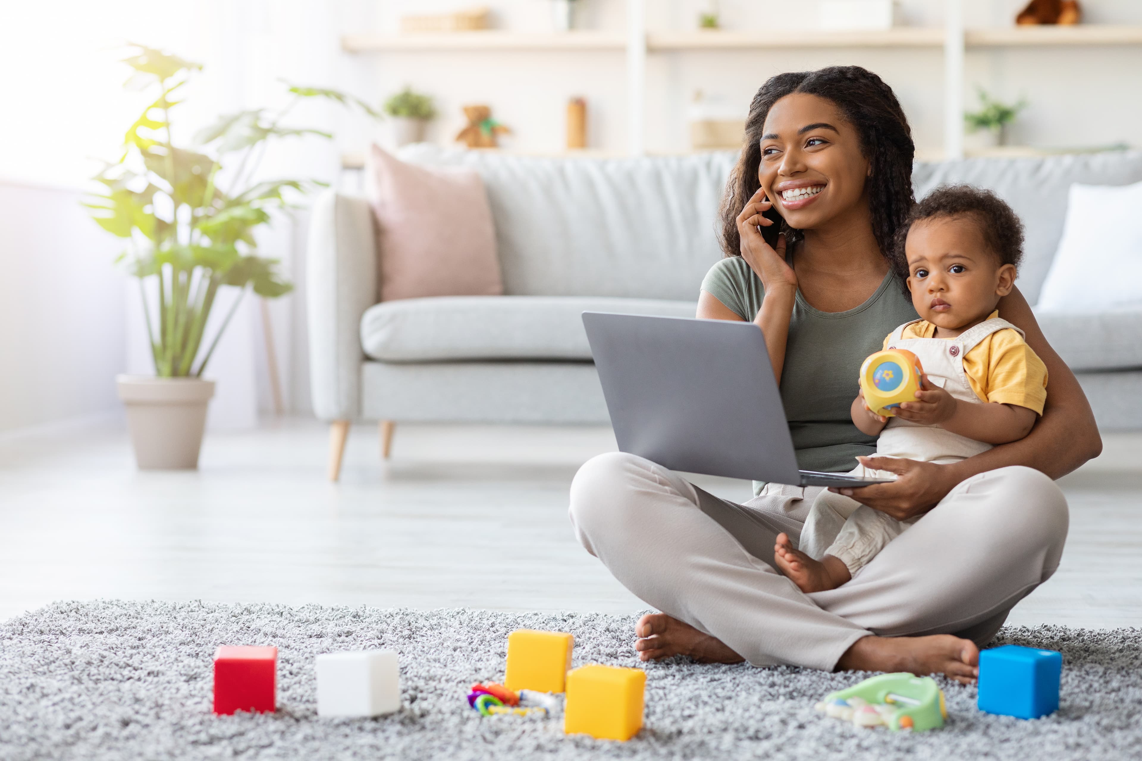 Mom Using Laptop And Talking On Cellphone