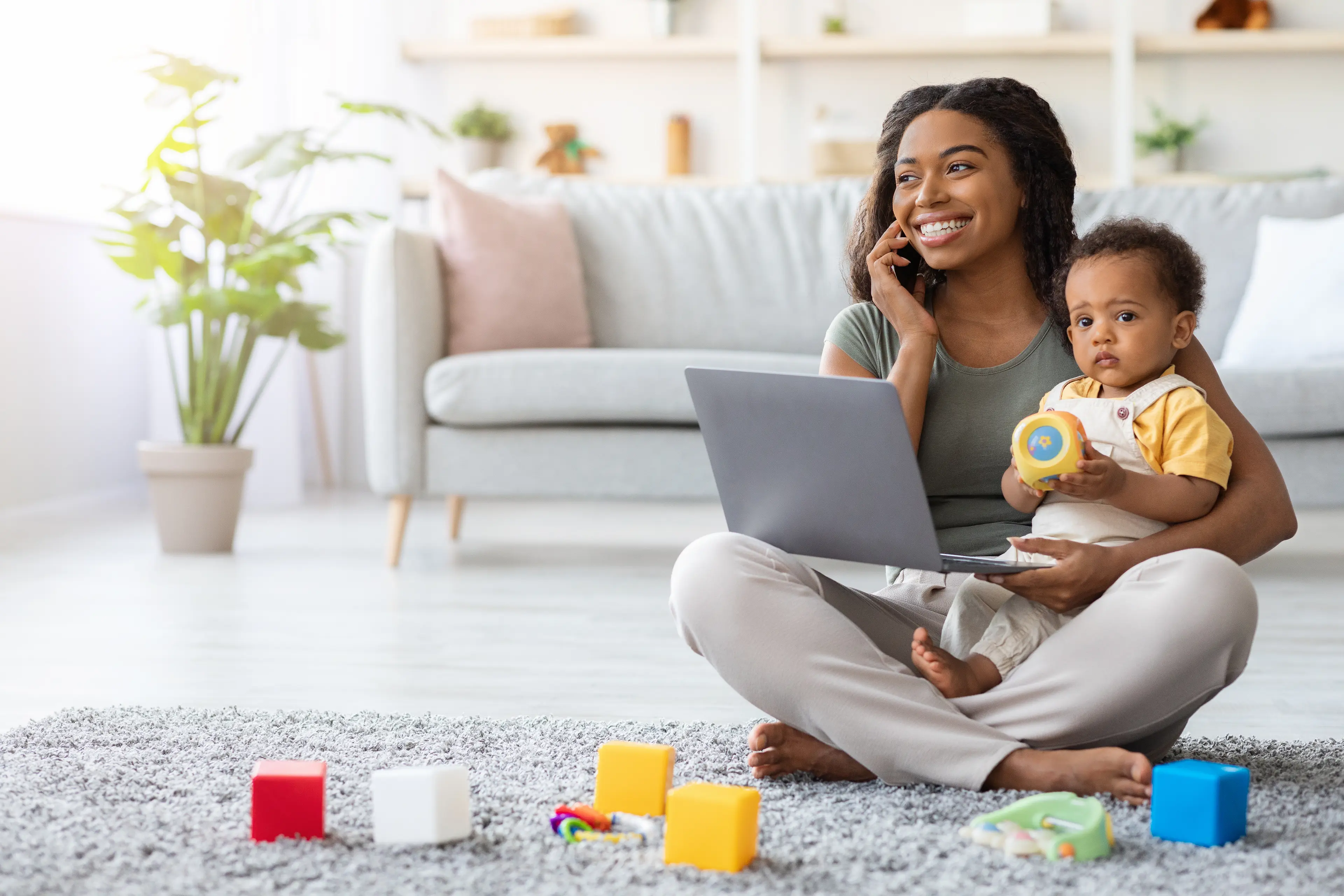 Mom Using Laptop And Talking On Cellphone
