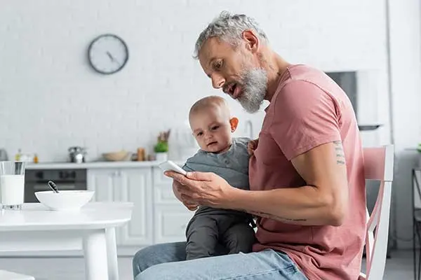 Mom on the phone while holding her child