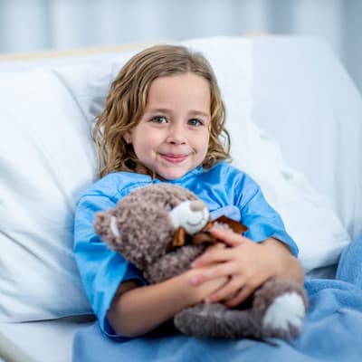 Children's Nebraska providers performing surgery on young patient in Children's Nebraska hospital operating room.