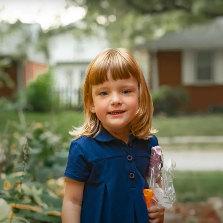 Marly, a Children's Nebraska patient, smiling outside.