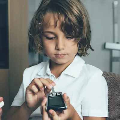 Child checking blood sugar.