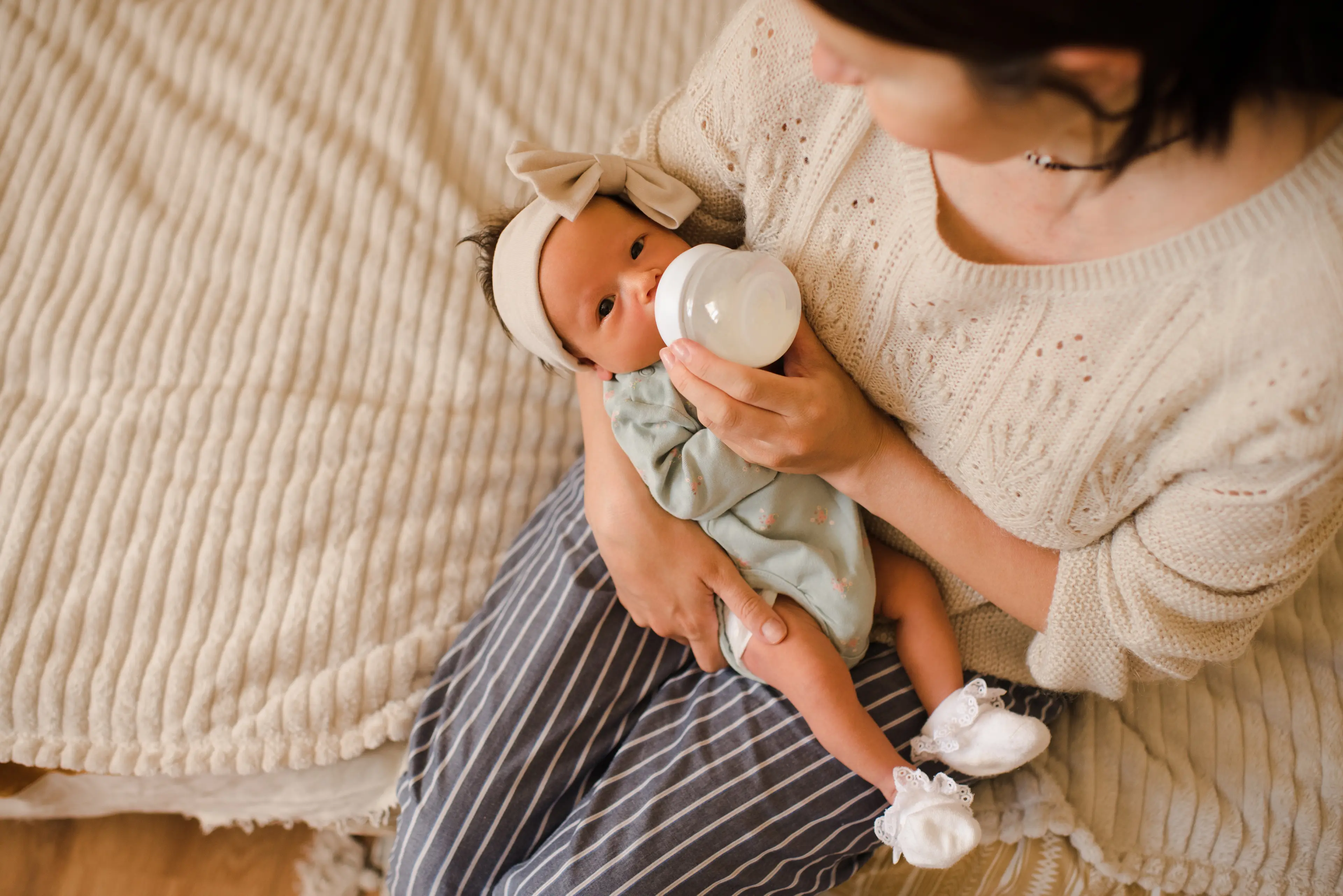 Mom feeding a baby with a bottle