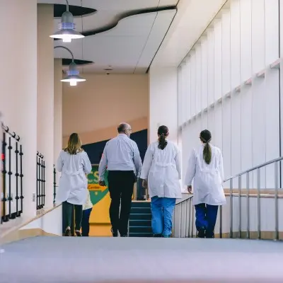 Medical providers walking together down hallway.