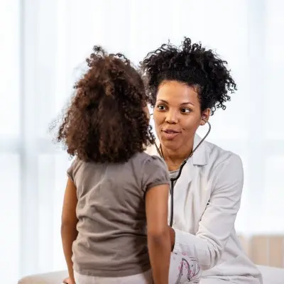 Provider examining young patient.