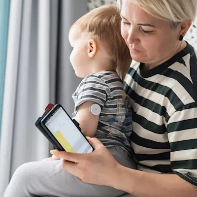 Mother checking child's blood sugar.