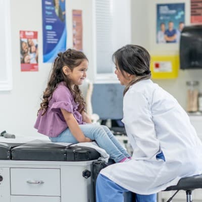 Nurse examining young patient.