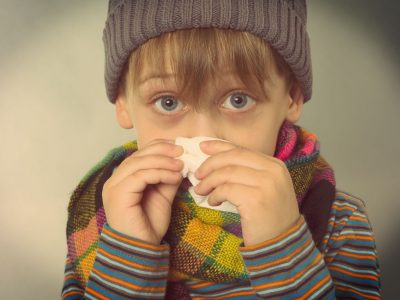 a child blowing his nose