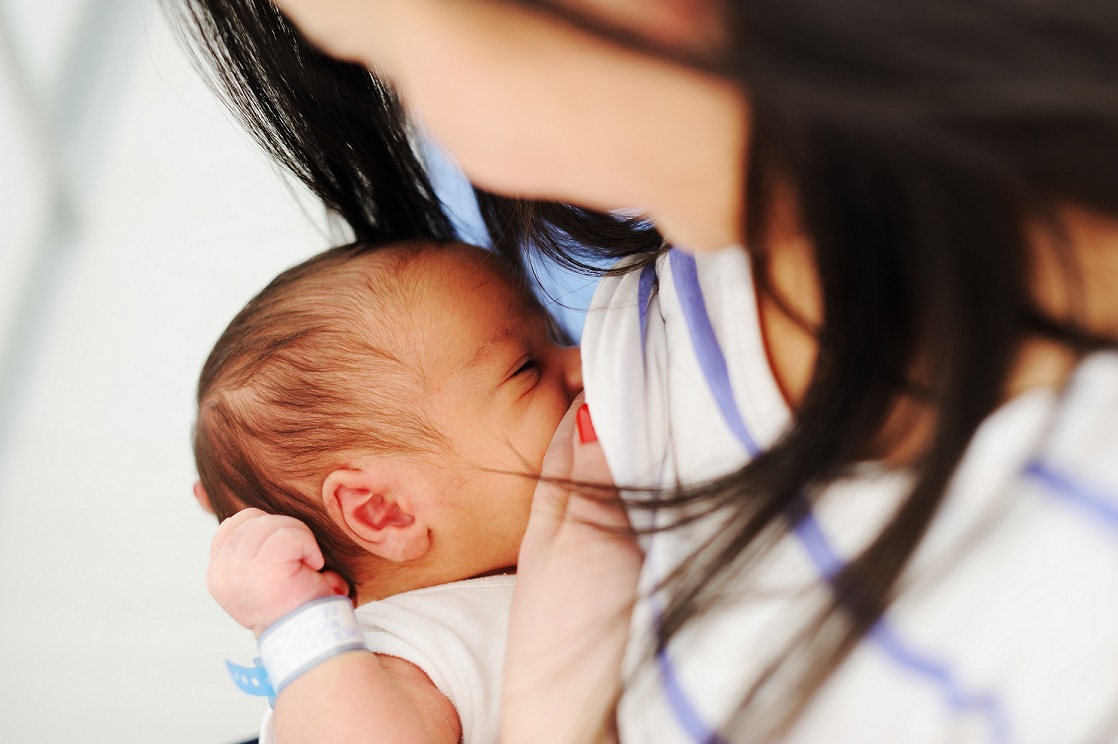 photo of woman breastfeeding baby